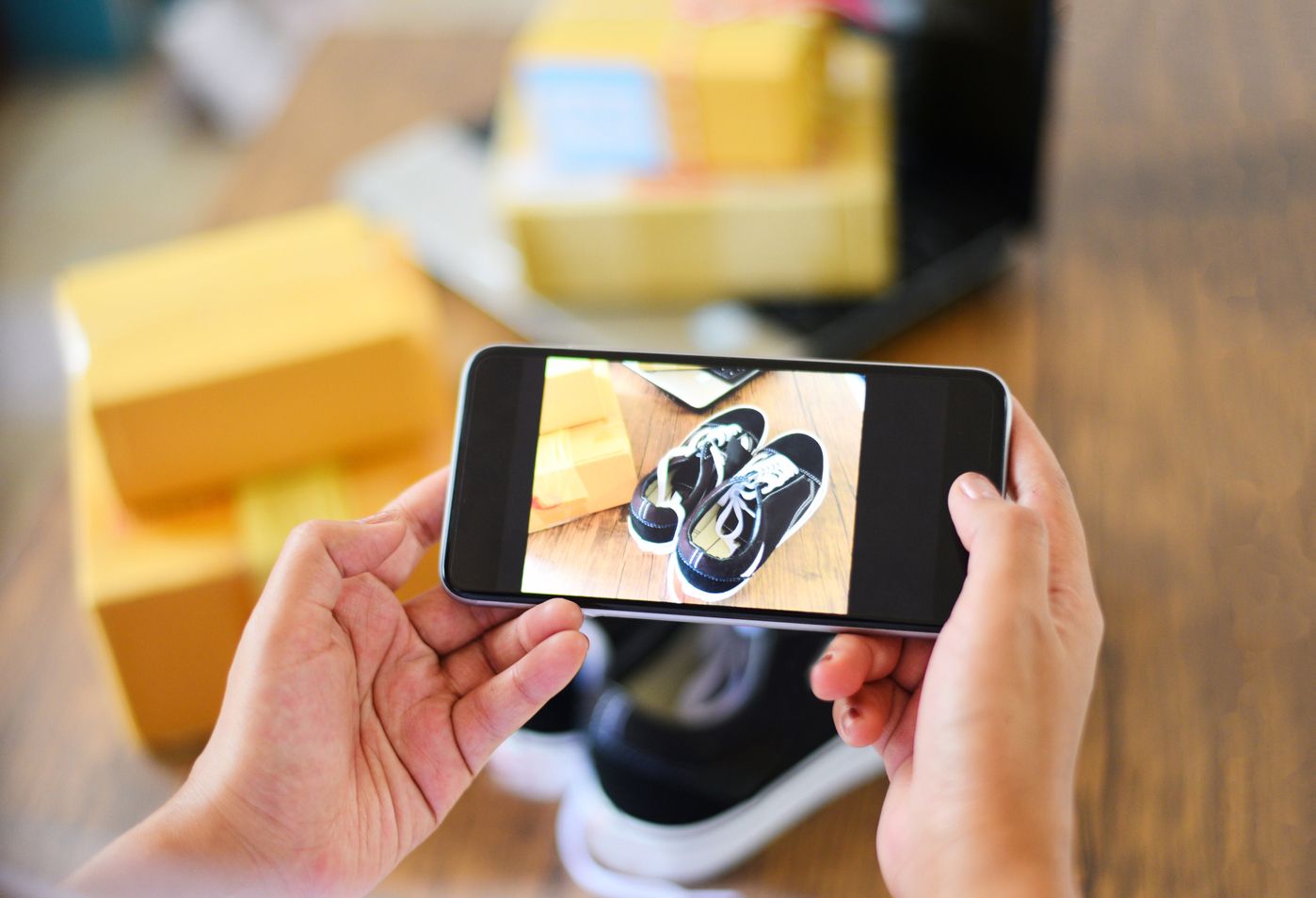 Person photographing shoes with phone for visual search